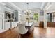 Elegant dining room featuring hardwood floors, a chandelier, and a built-in wine rack at 5114 Brendlynn Dr, Suwanee, GA 30024
