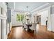 Formal dining room features a chandelier, wainscoting, and a large window overlooking the yard at 5114 Brendlynn Dr, Suwanee, GA 30024