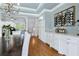 Dining room with hardwood floors, wine storage, and easy access to a kitchenette at 5114 Brendlynn Dr, Suwanee, GA 30024