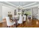 Dining room with hardwood floors and a view into the living area shows seamless floorplan at 5114 Brendlynn Dr, Suwanee, GA 30024