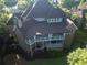 View of home's rear elevation with multiple decks and a brick facade at 5114 Brendlynn Dr, Suwanee, GA 30024