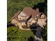 Beautiful brick and stone home with a well-manicured lawn and mature trees at 5114 Brendlynn Dr, Suwanee, GA 30024