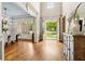 Elegant foyer with hardwood floors and natural light flowing in from the open doorway at 5114 Brendlynn Dr, Suwanee, GA 30024