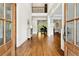 Grand foyer with hardwood floors, high ceilings, and an open view of the living spaces beyond at 5114 Brendlynn Dr, Suwanee, GA 30024