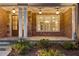 Charming front porch with brick columns and manicured landscaping, offering a welcoming entrance and inviting ambiance at 5114 Brendlynn Dr, Suwanee, GA 30024