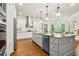 Bright kitchen with a central island, stainless steel appliances, hardwood floors and lots of natural light at 5114 Brendlynn Dr, Suwanee, GA 30024