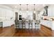 A spacious kitchen featuring a large center island, stainless steel appliances, and modern lighting at 5114 Brendlynn Dr, Suwanee, GA 30024