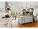 Kitchen featuring stainless appliances, a central island, and granite countertops at 5114 Brendlynn Dr, Suwanee, GA 30024