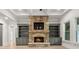 Open concept living room with a stone fireplace, built in bookshelves, coffered ceilings, and hardwood flooring at 5114 Brendlynn Dr, Suwanee, GA 30024
