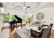 View of the living room with a piano, coffered ceilings, stone fireplace, and hardwood floors at 5114 Brendlynn Dr, Suwanee, GA 30024