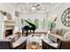 This living room is spacious and bright, featuring a fireplace, and a view of the piano at 5114 Brendlynn Dr, Suwanee, GA 30024