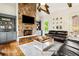 Comfortable living room with stone fireplace, hardwood floors and built-in shelving at 5114 Brendlynn Dr, Suwanee, GA 30024