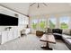 Bright living room featuring built-in cabinets, desk, and large windows showcasing the lush greenery at 5114 Brendlynn Dr, Suwanee, GA 30024