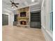 Bright living room featuring a stone fireplace, built-in bookshelves, and coffered ceiling at 5114 Brendlynn Dr, Suwanee, GA 30024