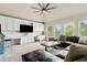 Bright living room featuring built-in cabinets, desk, and large windows showcasing the lush greenery at 5114 Brendlynn Dr, Suwanee, GA 30024
