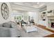 Bright living room boasts hardwood floors, coffered ceilings, fireplace, and a view into the dining room at 5114 Brendlynn Dr, Suwanee, GA 30024