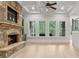 Bright open living room featuring a stone fireplace, built in shelves and a coffered ceiling at 5114 Brendlynn Dr, Suwanee, GA 30024