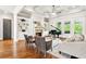 Open living room with coffered ceiling, fireplace, built-ins, and a grand piano at 5114 Brendlynn Dr, Suwanee, GA 30024