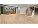 Open living space featuring hardwood floors, a stone kitchen island, and a staircase at 5114 Brendlynn Dr, Suwanee, GA 30024