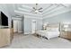 Spacious primary bedroom with trey ceilings, carpet, large windows, and en-suite bathroom at 5114 Brendlynn Dr, Suwanee, GA 30024
