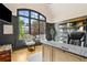 Elegant home office features a large window, custom bookshelves and a stylish desk at 5114 Brendlynn Dr, Suwanee, GA 30024