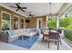 Relax on this spacious outdoor patio with a full brick fireplace and overhead ceiling fans at 5114 Brendlynn Dr, Suwanee, GA 30024