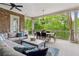 Enjoy this comfortable outdoor living space on a covered patio with scenic green views at 5114 Brendlynn Dr, Suwanee, GA 30024