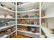 Spacious pantry with custom shelving and ample storage for food items and kitchen essentials at 5114 Brendlynn Dr, Suwanee, GA 30024