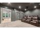 Home theater room with comfortable seating, projector, and sound system at 5114 Brendlynn Dr, Suwanee, GA 30024