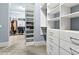 Spacious walk-in closet with custom built-in shelving and ample storage space at 5114 Brendlynn Dr, Suwanee, GA 30024