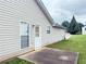 View of home exterior showing back door leading to concrete patio at 2658 Deann Dr, Ellenwood, GA 30294