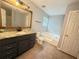 Bathroom featuring a soaking tub, walk-in shower and granite countertop vanity at 2658 Deann Dr, Ellenwood, GA 30294
