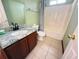 Cozy bathroom with a granite vanity, tile floors, and shower-tub combo at 2658 Deann Dr, Ellenwood, GA 30294