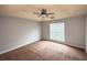 Spacious bedroom featuring neutral walls, carpet and a ceiling fan at 2658 Deann Dr, Ellenwood, GA 30294