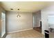 Cozy dining area adjacent to the kitchen with modern light fixture at 2658 Deann Dr, Ellenwood, GA 30294