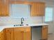 The kitchen features stainless steel appliances, a new countertop, backsplash, and wooden cabinets at 2658 Deann Dr, Ellenwood, GA 30294