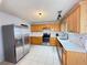 Bright kitchen features stainless steel appliances, white countertops, white backsplash, and wooden cabinets at 2658 Deann Dr, Ellenwood, GA 30294
