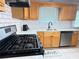 Updated kitchen with light wood cabinets, white countertop and backsplash at 2658 Deann Dr, Ellenwood, GA 30294