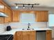 Close-up on kitchen featuring stainless steel appliances, track lighting, and white countertops and backsplash at 2658 Deann Dr, Ellenwood, GA 30294