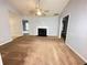 Well-lit living room features a fireplace, ceiling fan, and connections for TV at 2658 Deann Dr, Ellenwood, GA 30294