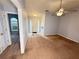 Spacious living room leads to the front door and features neutral paint and carpet at 2658 Deann Dr, Ellenwood, GA 30294