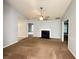 Cozy living room with fireplace, ceiling fan, and light-colored walls at 2658 Deann Dr, Ellenwood, GA 30294