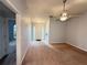 Spacious living room leads to the front door and features neutral paint and carpet at 2658 Deann Dr, Ellenwood, GA 30294