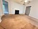 Spacious living room with a fireplace, ceiling fan, and neutral carpet at 2658 Deann Dr, Ellenwood, GA 30294