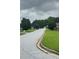 Neighborhood street view with tree-lined sidewalks and well-maintained lawns at 2658 Deann Dr, Ellenwood, GA 30294