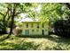 The expansive backyard features mature trees, a wooden deck, and upper-level porch at 2831 Carolyn Se Dr, Smyrna, GA 30080