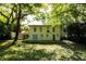 The expansive backyard features mature trees, a wooden deck, and upper-level porch at 2831 Carolyn Se Dr, Smyrna, GA 30080