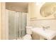 Neutral bathroom with a glass-enclosed shower, pedestal sink, and classic fixtures at 2831 Carolyn Se Dr, Smyrna, GA 30080