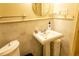 Classic bathroom features a pedestal sink with tile backsplash and a round mirror at 2831 Carolyn Se Dr, Smyrna, GA 30080