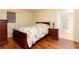 Bedroom featuring hardwood floors, wood furniture, and a charming doorway to another room at 2831 Carolyn Se Dr, Smyrna, GA 30080
